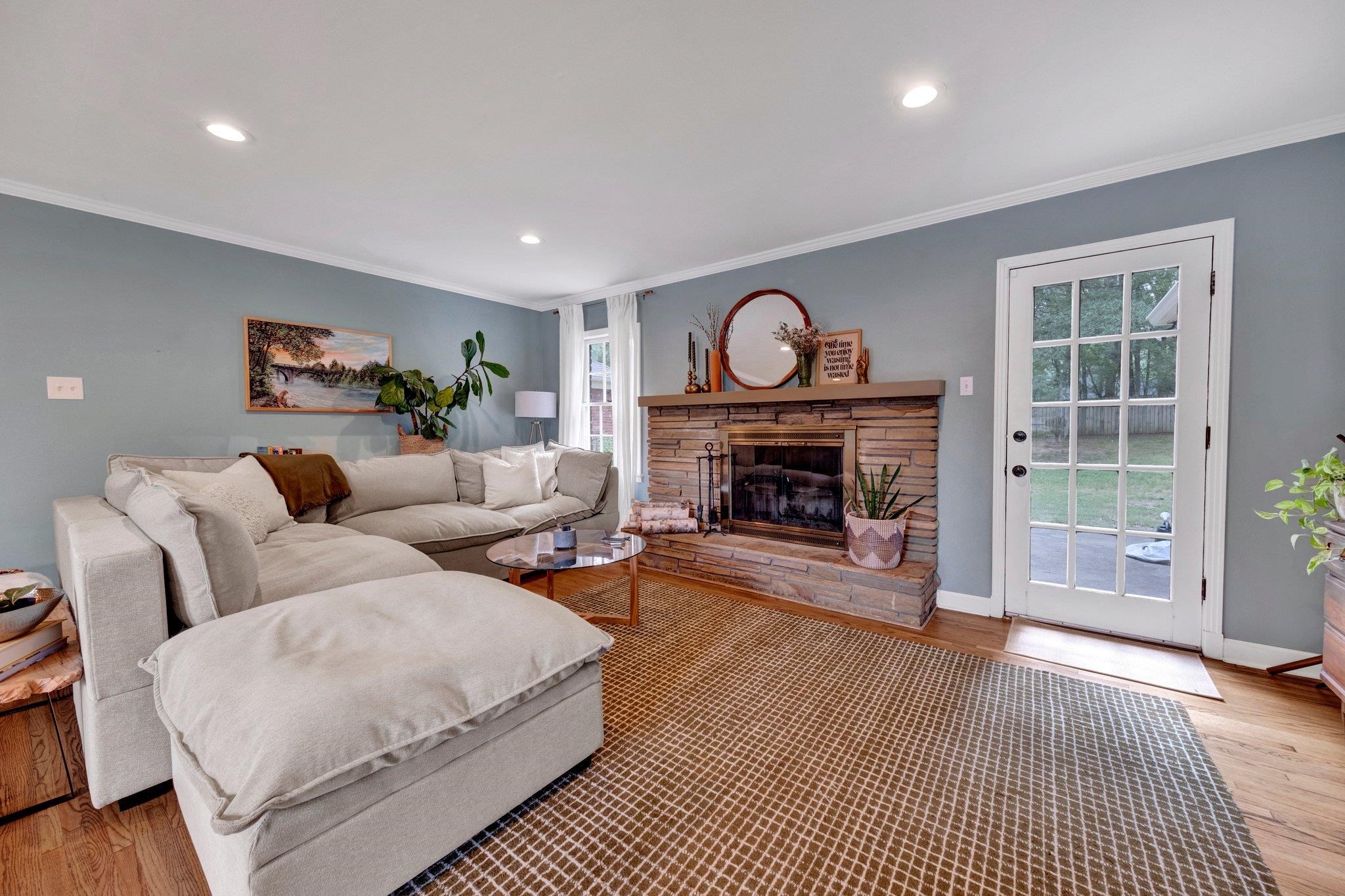 5543 Walnut Grove Road Memphis, TN 38120 - Photo 5 of 25 a living room with furniture a fireplace and a window