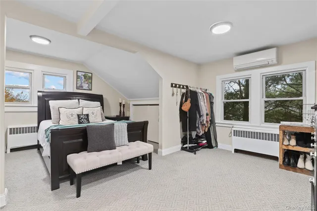 a bedroom with furniture and a window