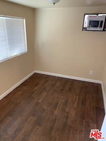 a view of room with window and wooden floor