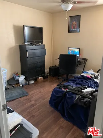 a bedroom with a bed and flat screen tv