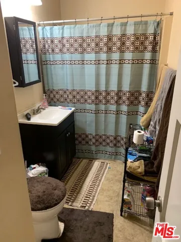 a bathroom with a sink mirror and vanity