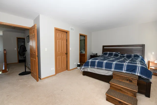 a bedroom with a bed and cabinets