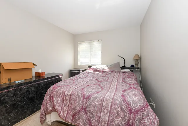 a bedroom with double bed and a lamp