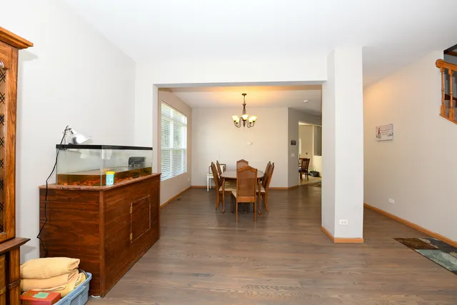 a living room with furniture and a dining table