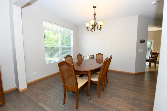 a view of a dining room with furniture wooden floor and a chandelier