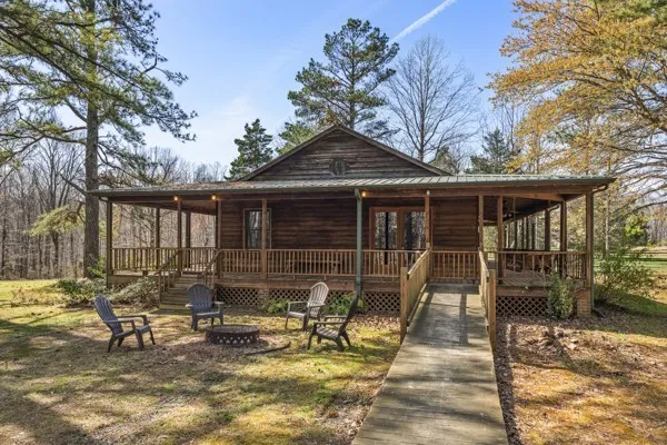 a view of a house with backyard sitting area and garden