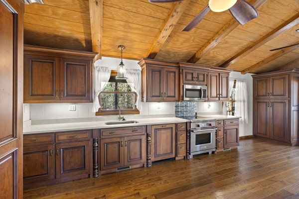 3778 Highway 100 Centerville, TN 37033 - Photo 11 of 59 a kitchen with a sink cabinets wooden floor and stainless steel appliances