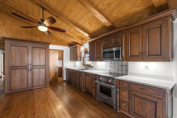 3778 Highway 100 Centerville, TN 37033 - Photo 12 of 59 a kitchen with stainless steel appliances granite countertop a stove a sink dishwasher and a refrigerator with wooden floor