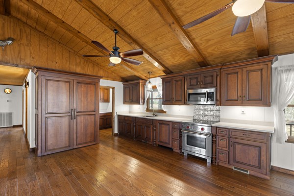 3778 Highway 100 Centerville, TN 37033 - Photo 10 of 59 a kitchen with stainless steel appliances granite countertop a stove a refrigerator a sink and dishwasher with wooden floor