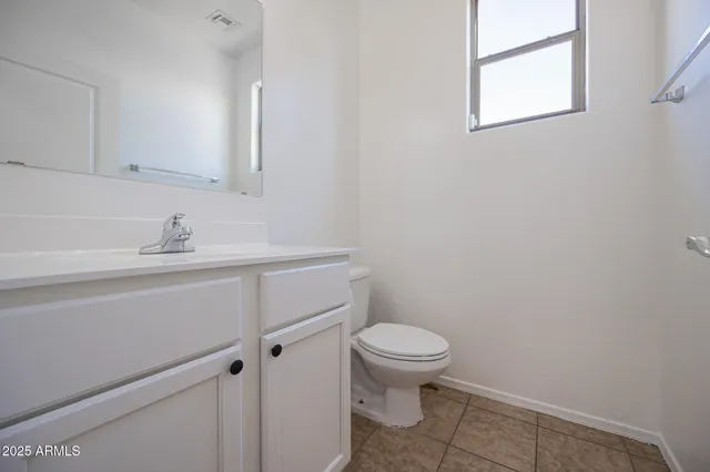 a bathroom with a sink toilet and a mirror