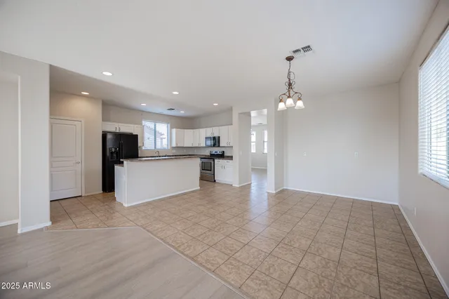 a view of kitchen with refrigerator sink and cabinets