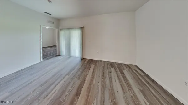 a view of a room with wooden floor
