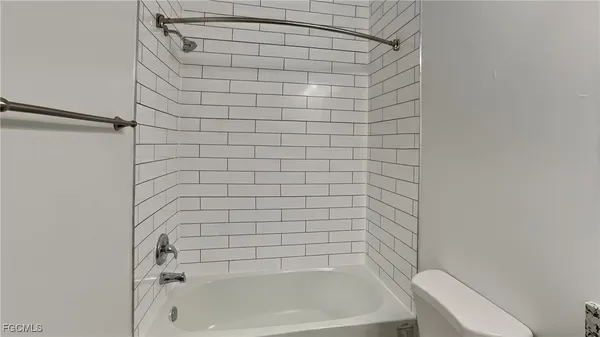 a bathroom with a bathtub and shower