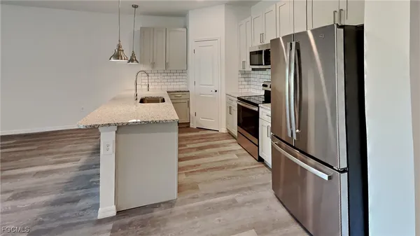 a kitchen with stainless steel appliances a refrigerator and a stove