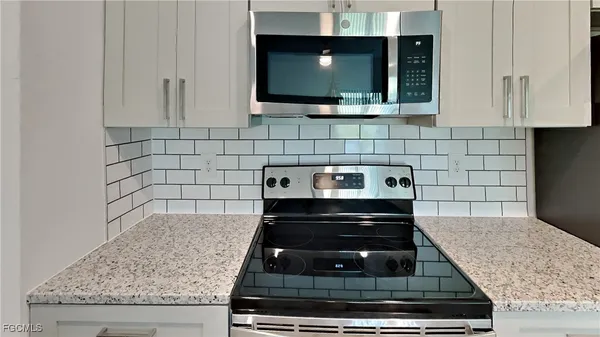a kitchen with microwave and stove
