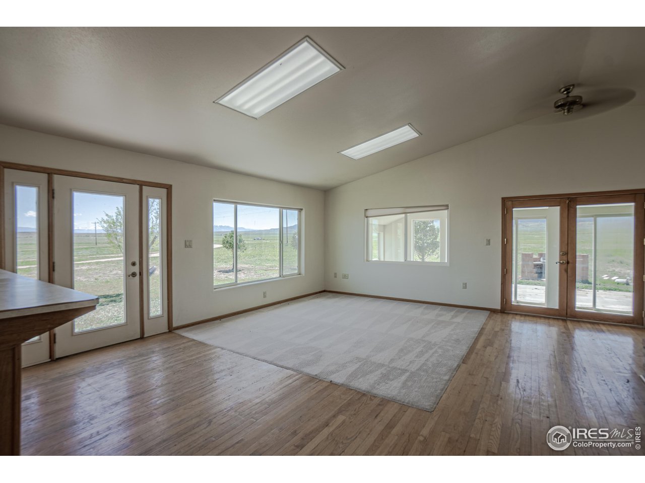 620 County Road 670 Rye, CO 81069 - Photo 18 of 40 a view of an empty room with glass door and wooden floor