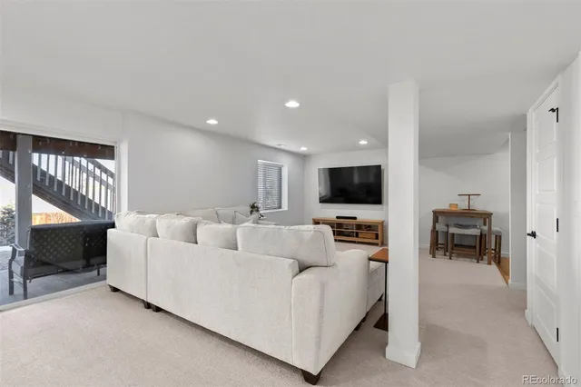a living room with furniture fireplace and flat screen tv