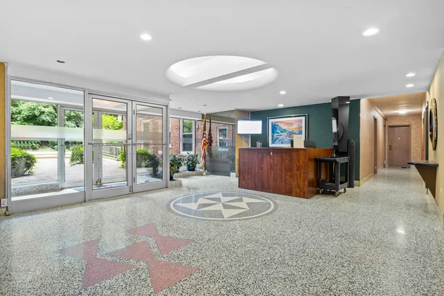 front view of a brick house with a yard