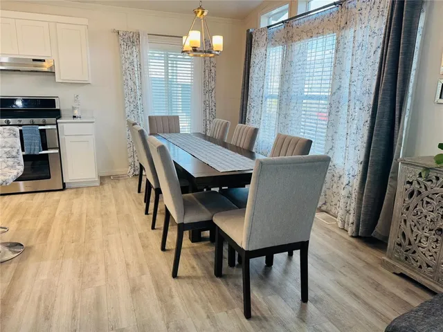 a kitchen with a sink stainless steel appliances and white cabinets