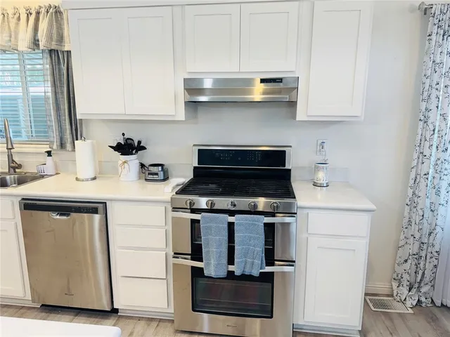 a large white kitchen with lots of counter space