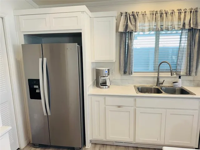 a living room with furniture a flat screen tv and a table