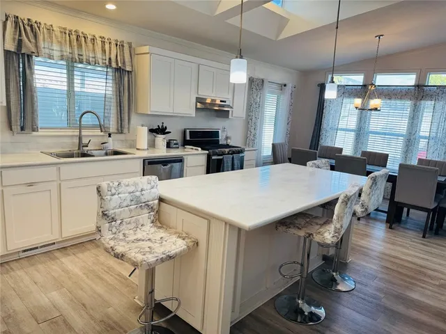 a bedroom with a bed a mirror and a window