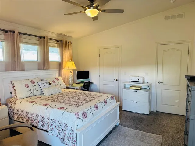 a bed sitting in a bedroom next to a window