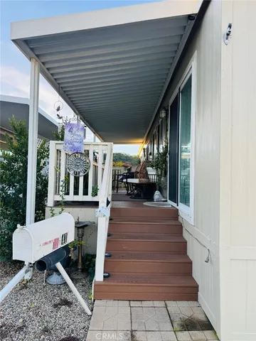 a view of a patio with table and chairs potted plants with wooden floor