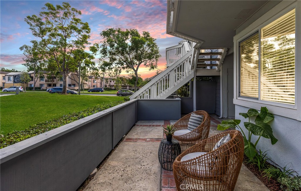 a balcony with furniture and a potted plant