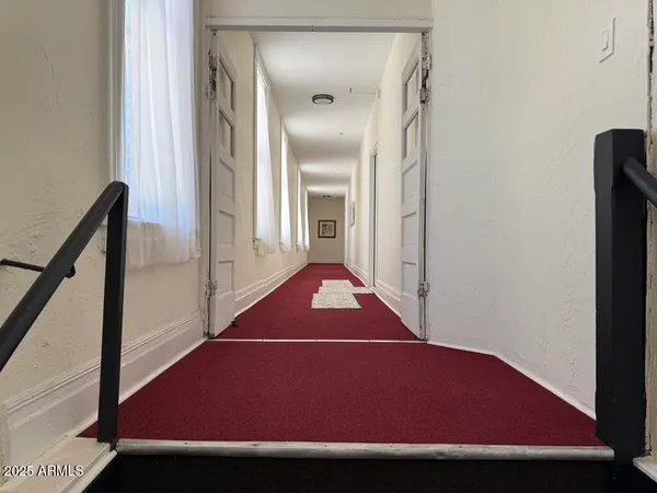 a view of a hallway with a wooden floor