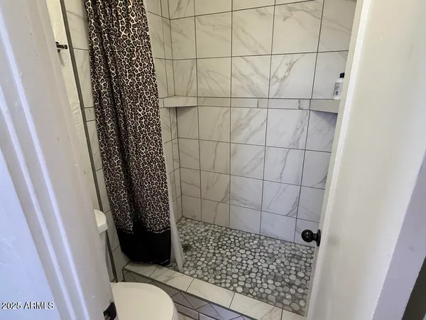 a bathroom with a granite countertop sink and a bathtub