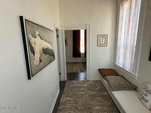 a bedroom with a bed a couch and a window