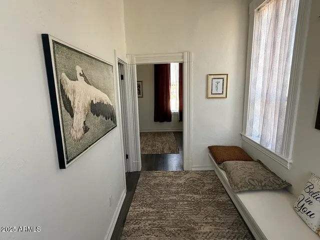 a bedroom with a bed a couch and a window