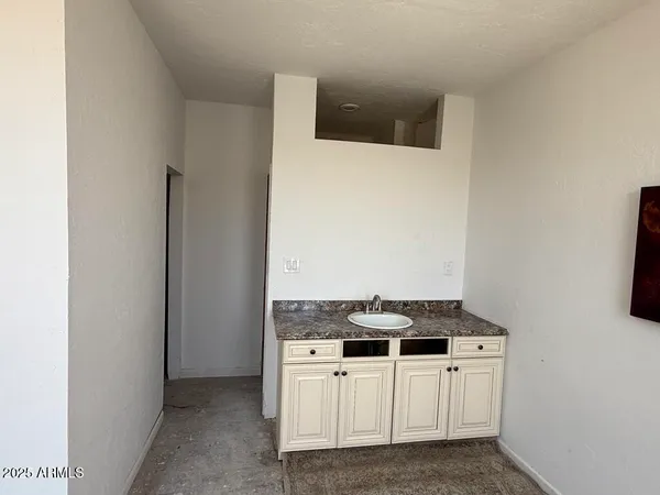 a white toilet sitting next to a bathroom sink