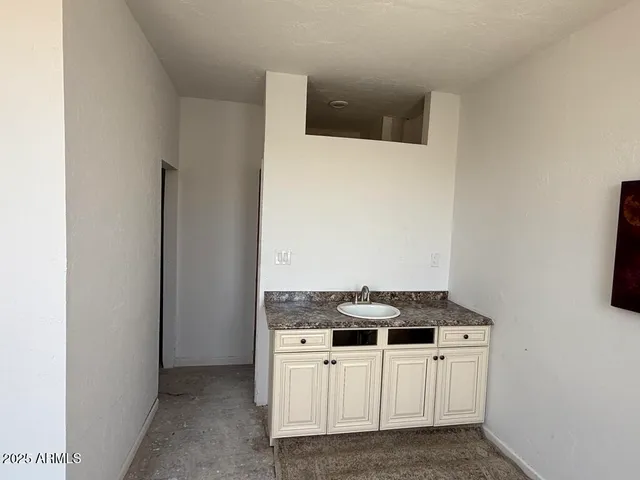 a white toilet sitting next to a bathroom sink