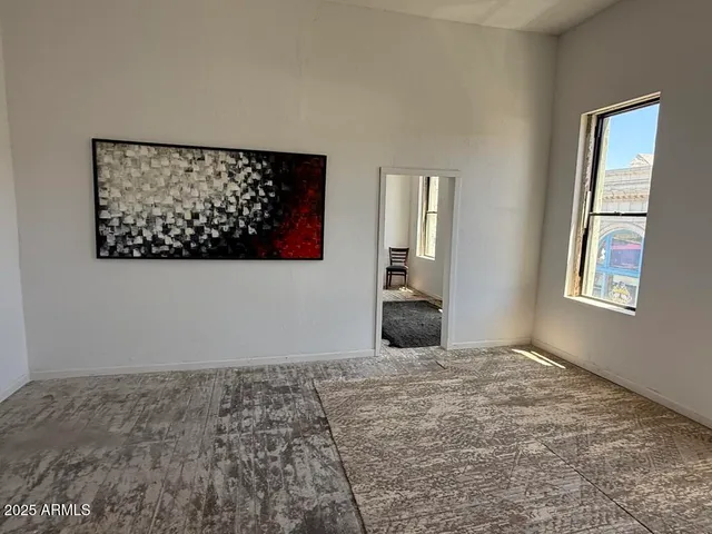 a bedroom with a bed and a dresser in it