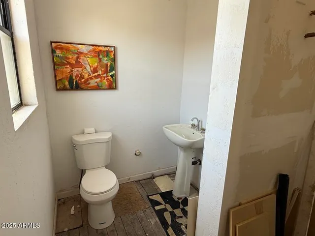 a view of livingroom with furniture a flat screen tv and windows