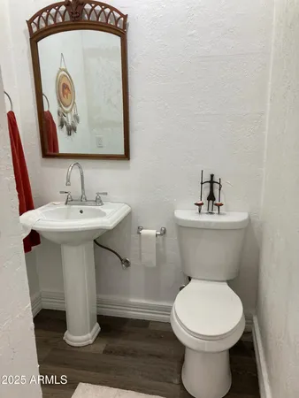a view of a livingroom with a furniture wooden floor and chandelier