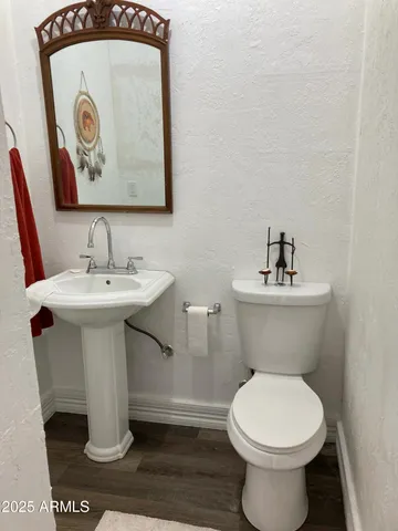 a view of a livingroom with a furniture wooden floor and chandelier