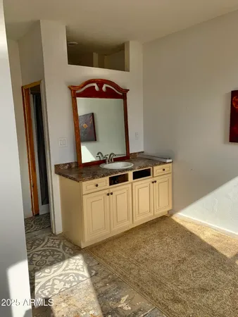 a view of a livingroom with wooden floor and a rug