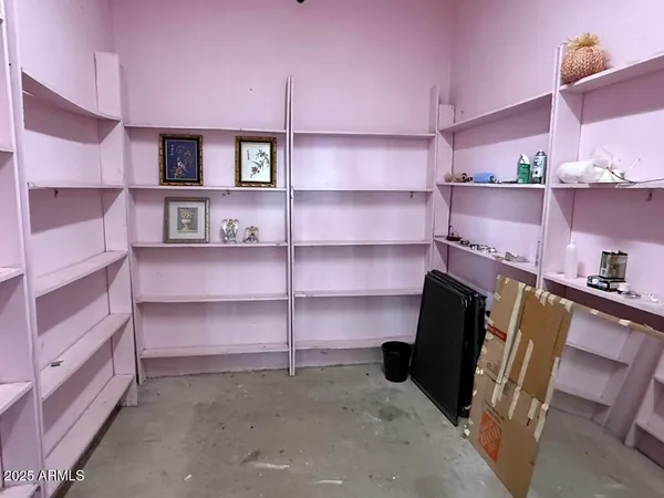 a view of workspace with cabinets and book shelf