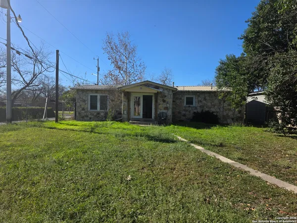 a view of a house with a yard and a garden