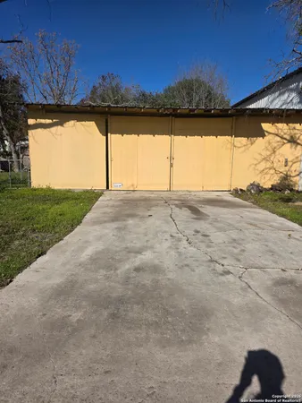 a view of large parking space with yard and outdoor seating