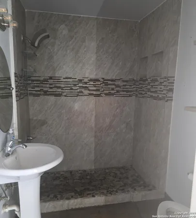 a bathroom with a sink and mirror