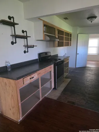 a kitchen with stainless steel appliances wooden cabinets and a stove top oven