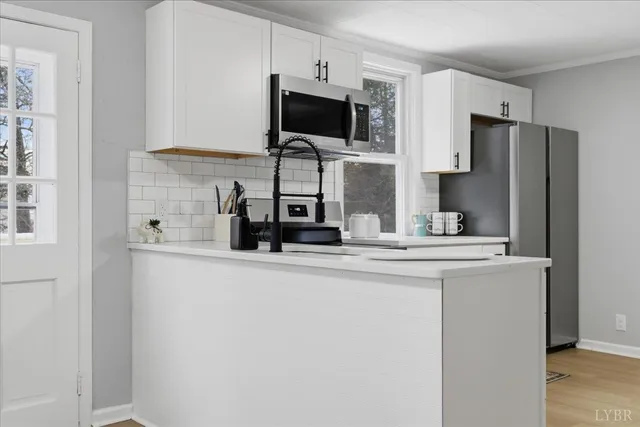 a kitchen with stainless steel appliances a refrigerator and a stove top oven