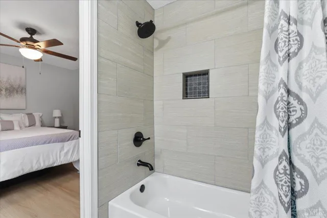 a bathroom with a bathtub and shower