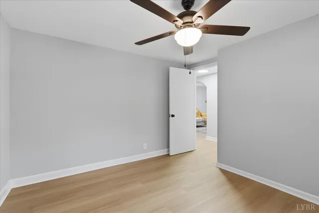 an empty room with a fan and a fan