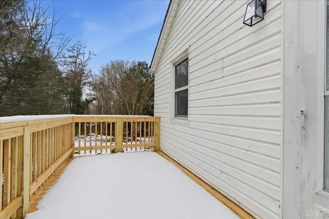 a view of a balcony with wooden fence and floor