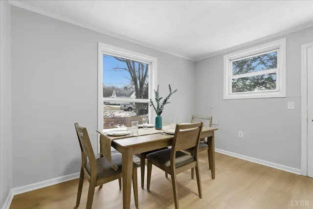 a view of a dining room with furniture and wooden floor
